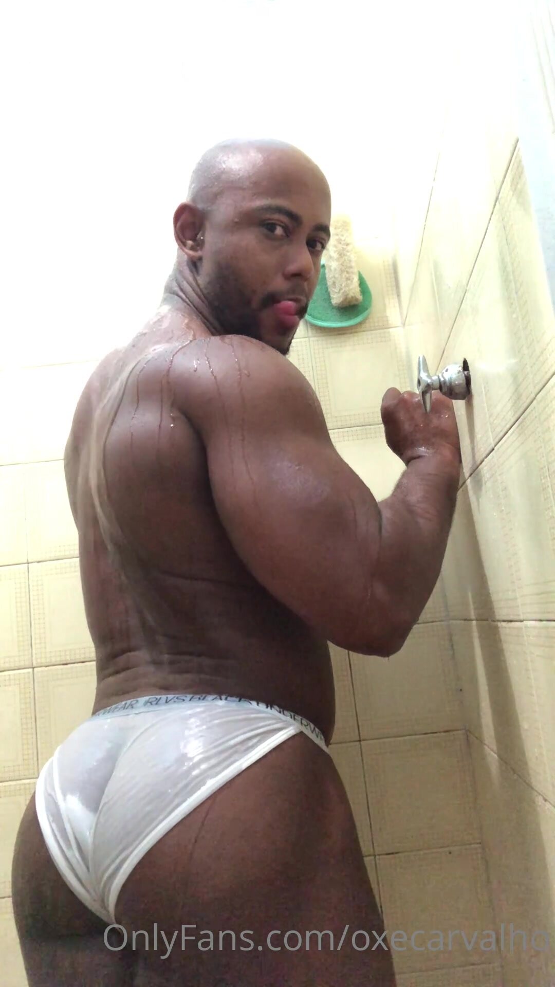 Black bodybuilder taking shower