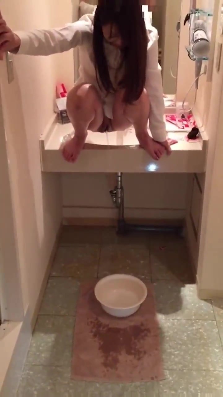 Cute JAP squat pees from sink into bucket on the floor