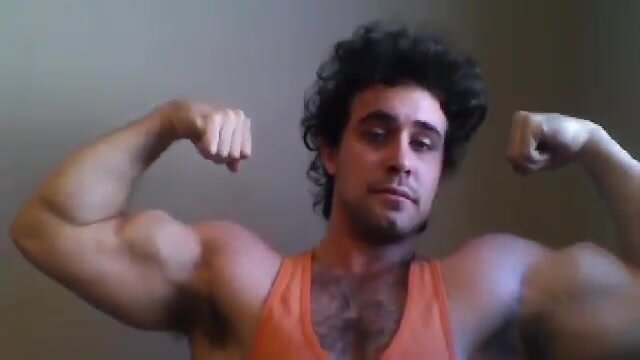 Jason Rhodes flexing biceps