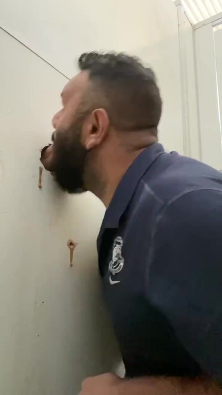 Bear sucks cock at a glory hole and gets the load