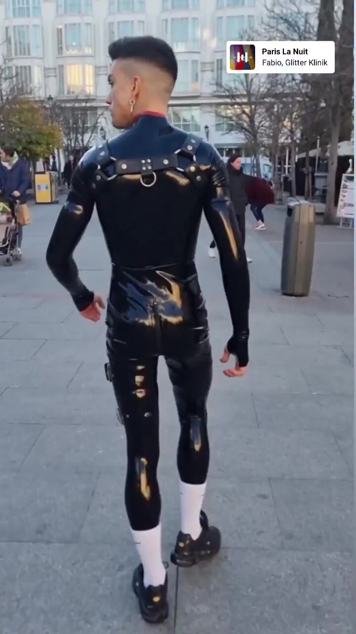 Young handsome guy in rubber on the street