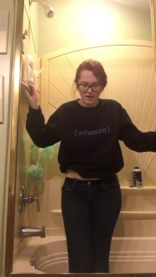 Redhead pees her jeans in the shower