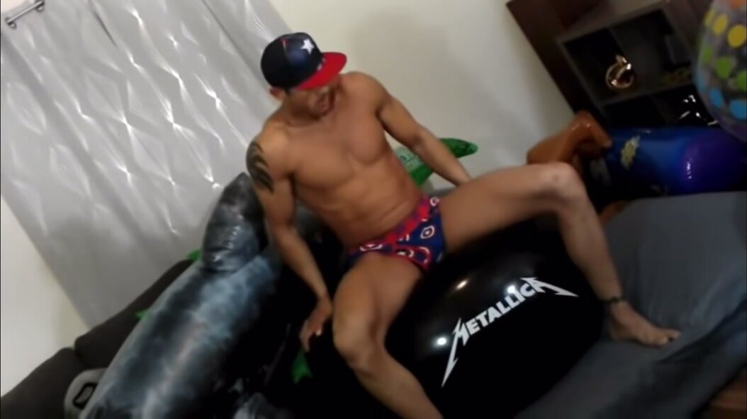 Hot fit guy plays with balloons