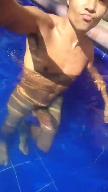 Skinny twink with boner in the pool.