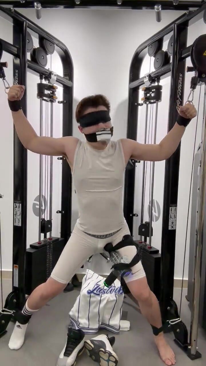 Chinese male sock gagged tied to gym rack with vibrator