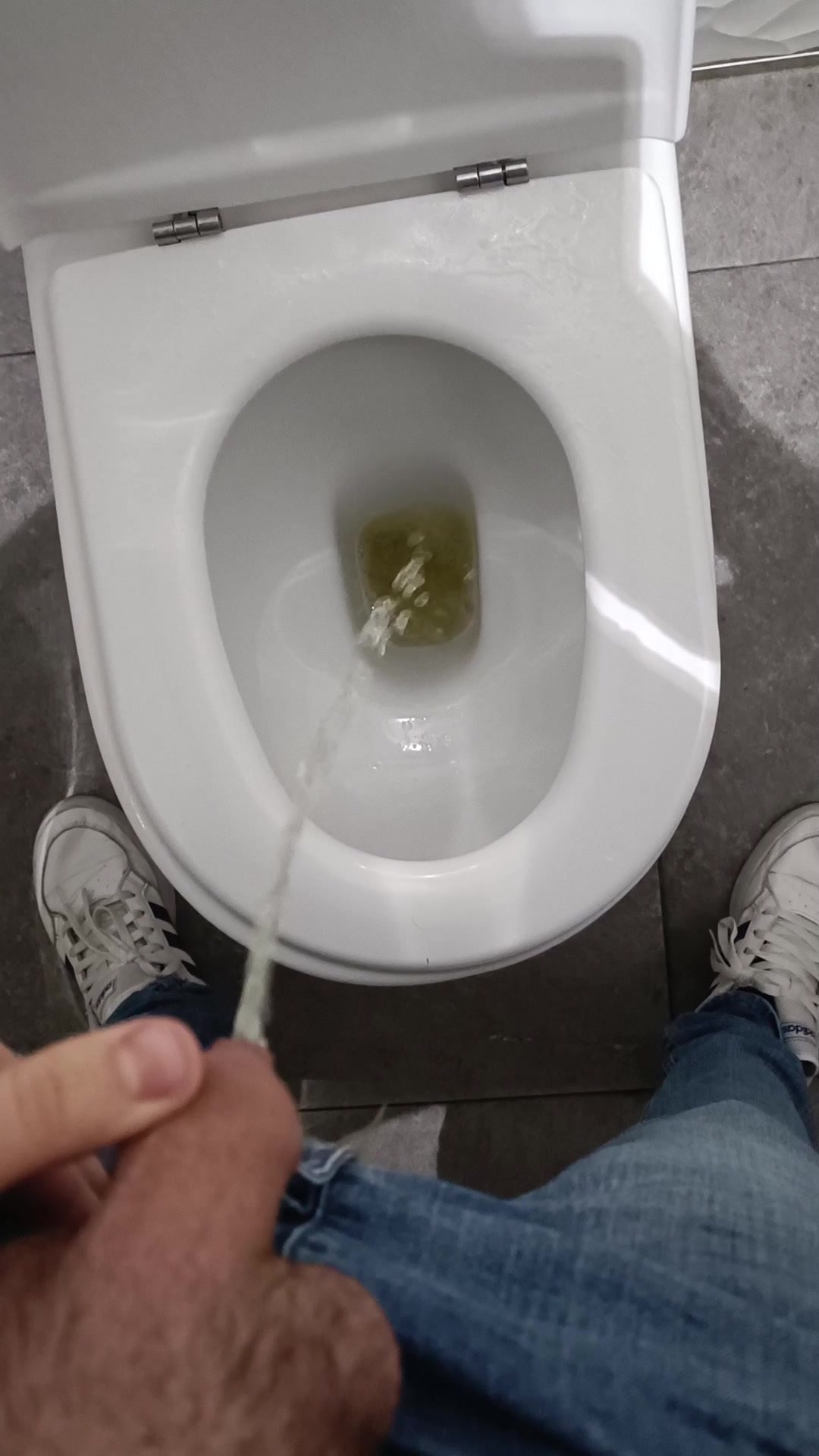 Boy pissing at the mall