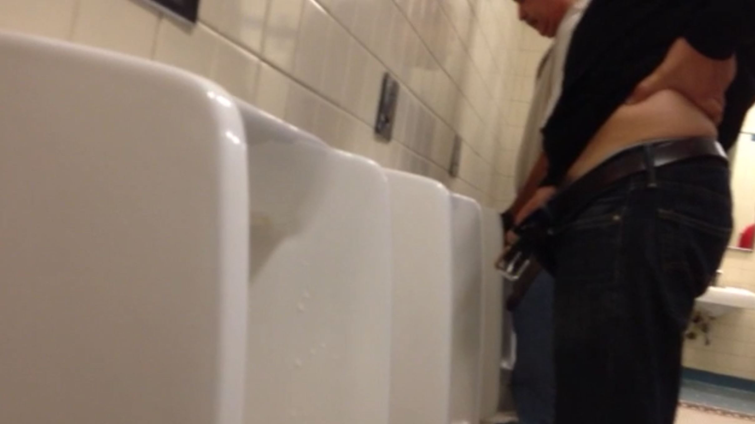 Proud big dick pissing at the urinal with hand on hip