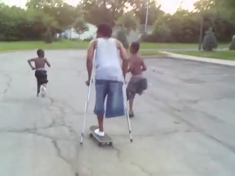 Amputee guy with crutches on skateboard
