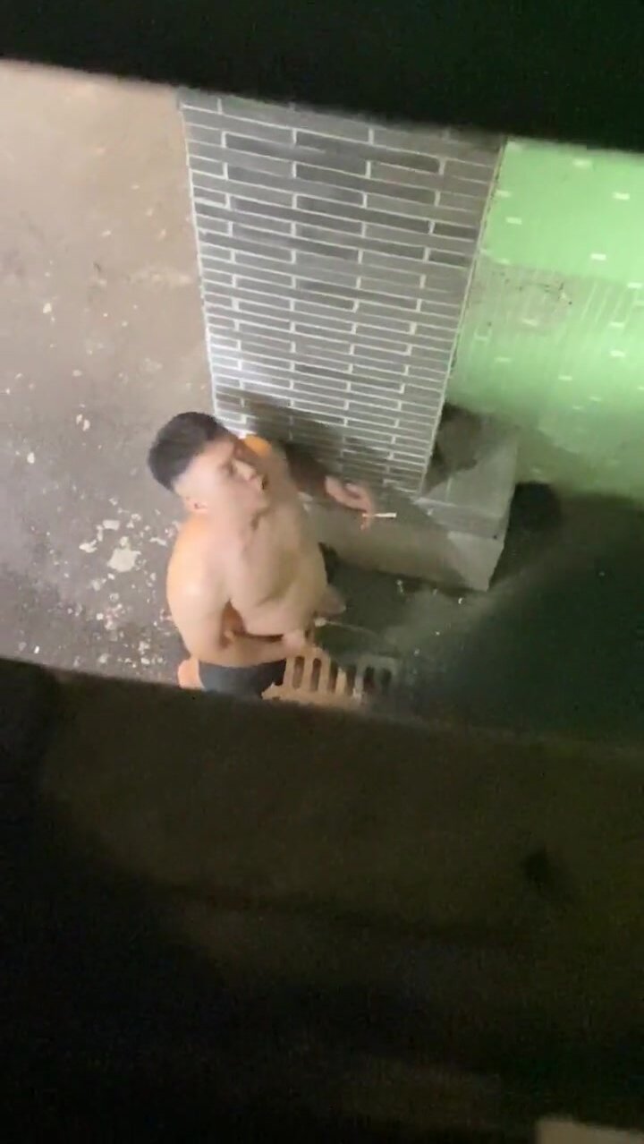 asian boy peeing in the street