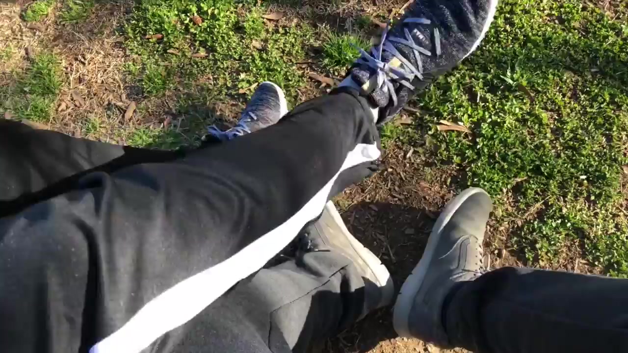 Two guys taking off shoes and socks
