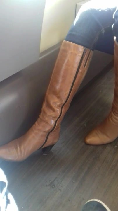 Woman in heeled boots and jeans candid shoeplay