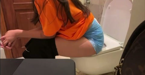 Girl pees in big diaper on the toilet