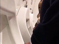 Guy spying on dicks at the urinal