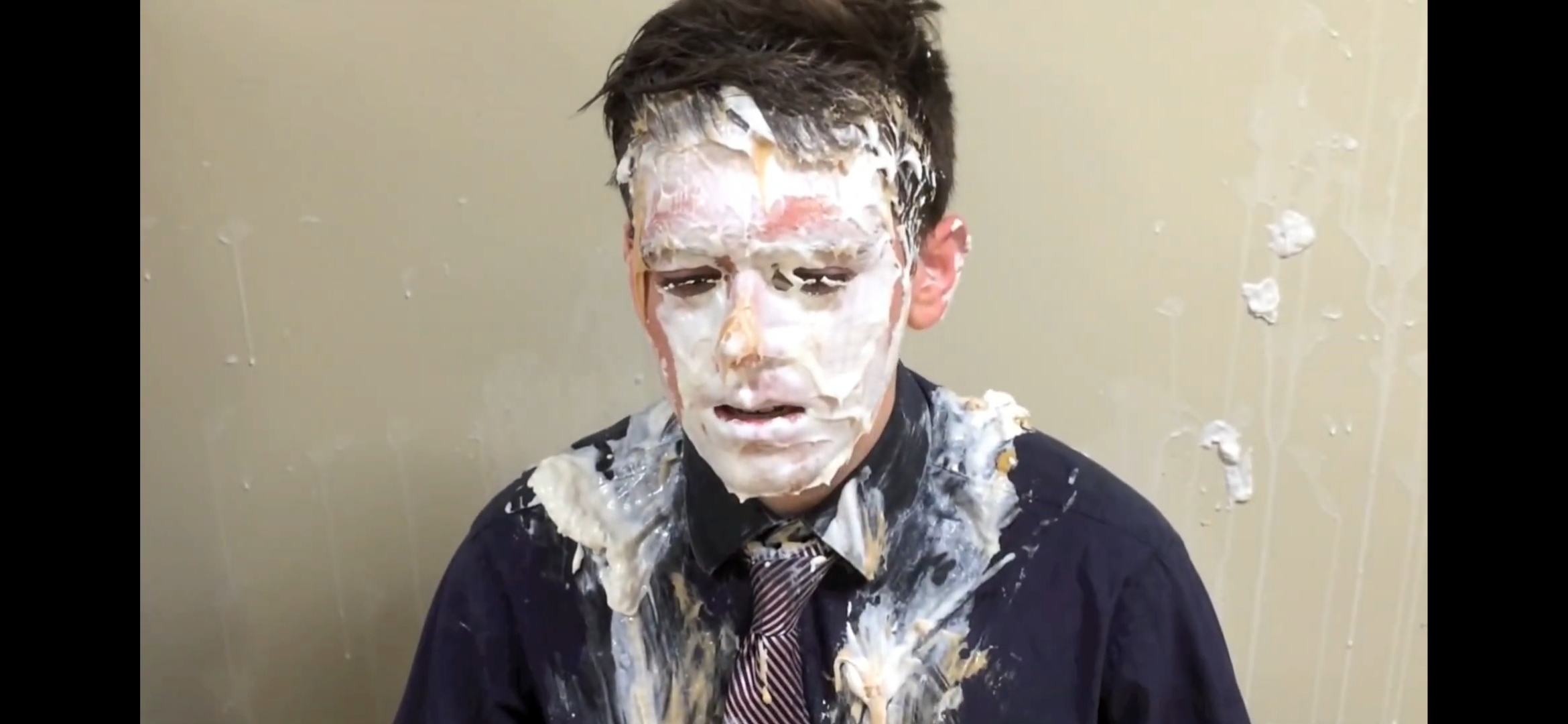 Handsome teen gets a pie in the face