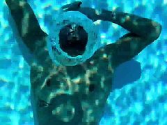 French fit swimmer blowing bubbles underwater