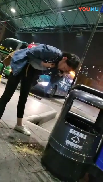 Chinese girl vomiting at bus terminus