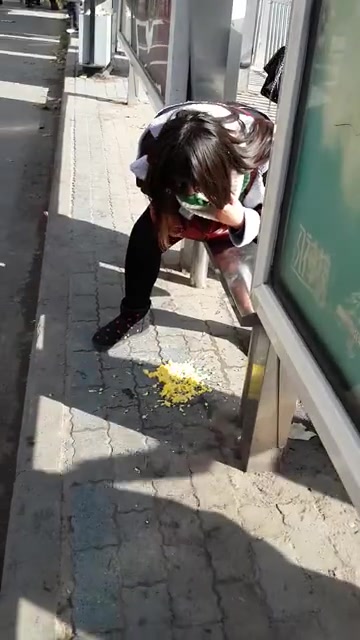 Chinese girl vomiting at bus stop