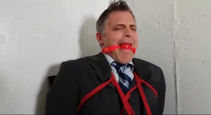 Ballgagged chairtied suited man