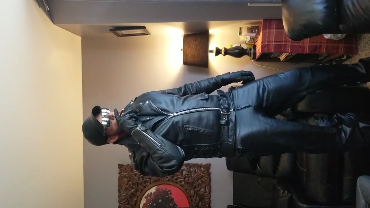 Leather daddy smoking in full Bluf leather gear.