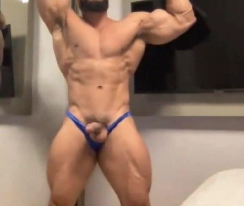 bodybuilder poses with cock out