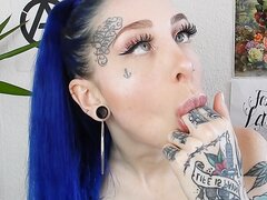 A beautiful girl with blue hair makes herself puke