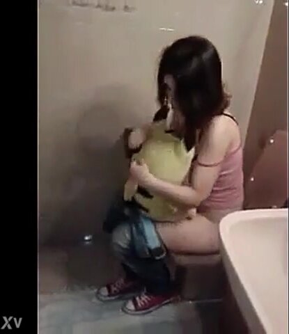 Girl peeing on toilet while holding Pikachu