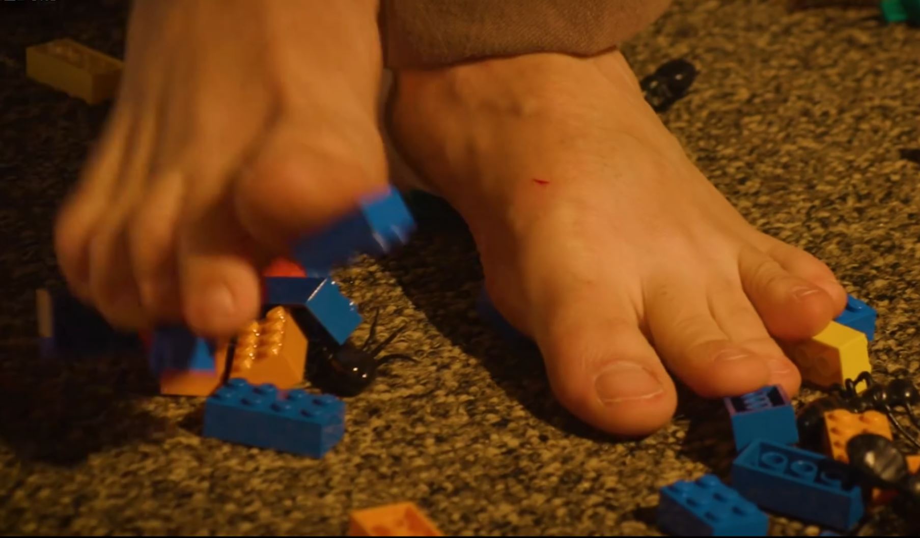 Barefoot on the floor full of lego