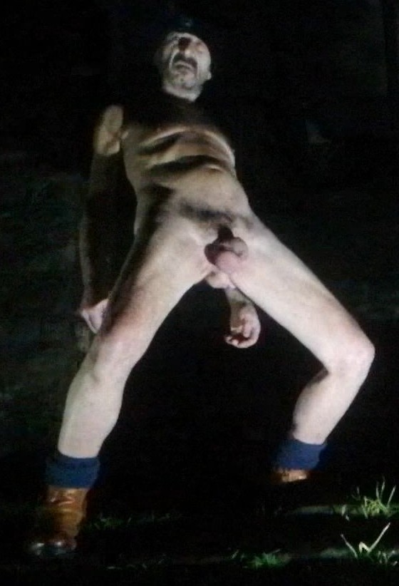 Guy nude outdoors in public park