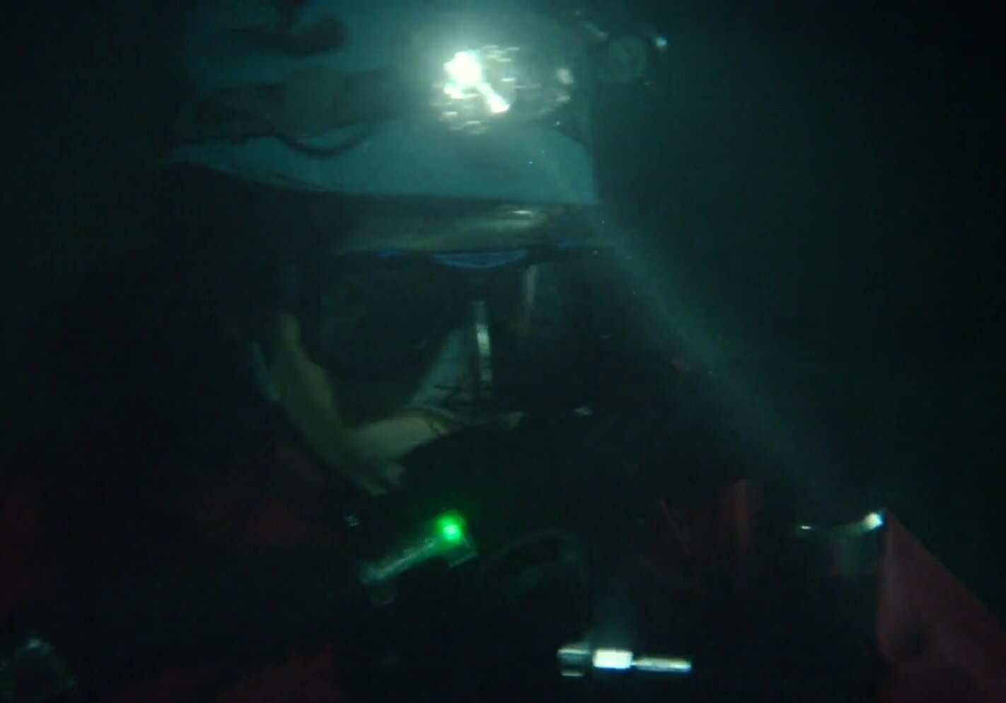 Rebreather divers in tight tunnel