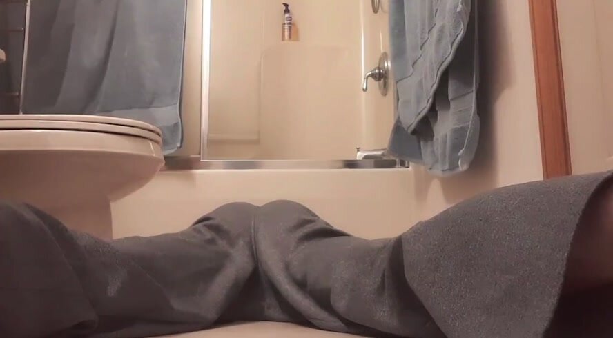 Guy pisses grey sweats laying down