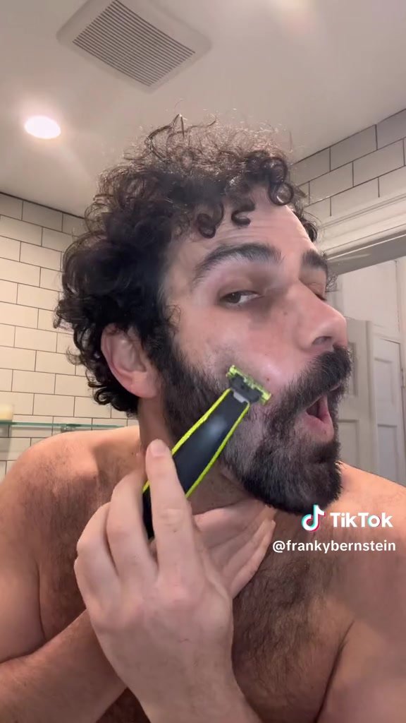 Sexy dude shaving his face