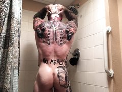 Beefy tattooed muscle bodybuilder takes a shower and cum