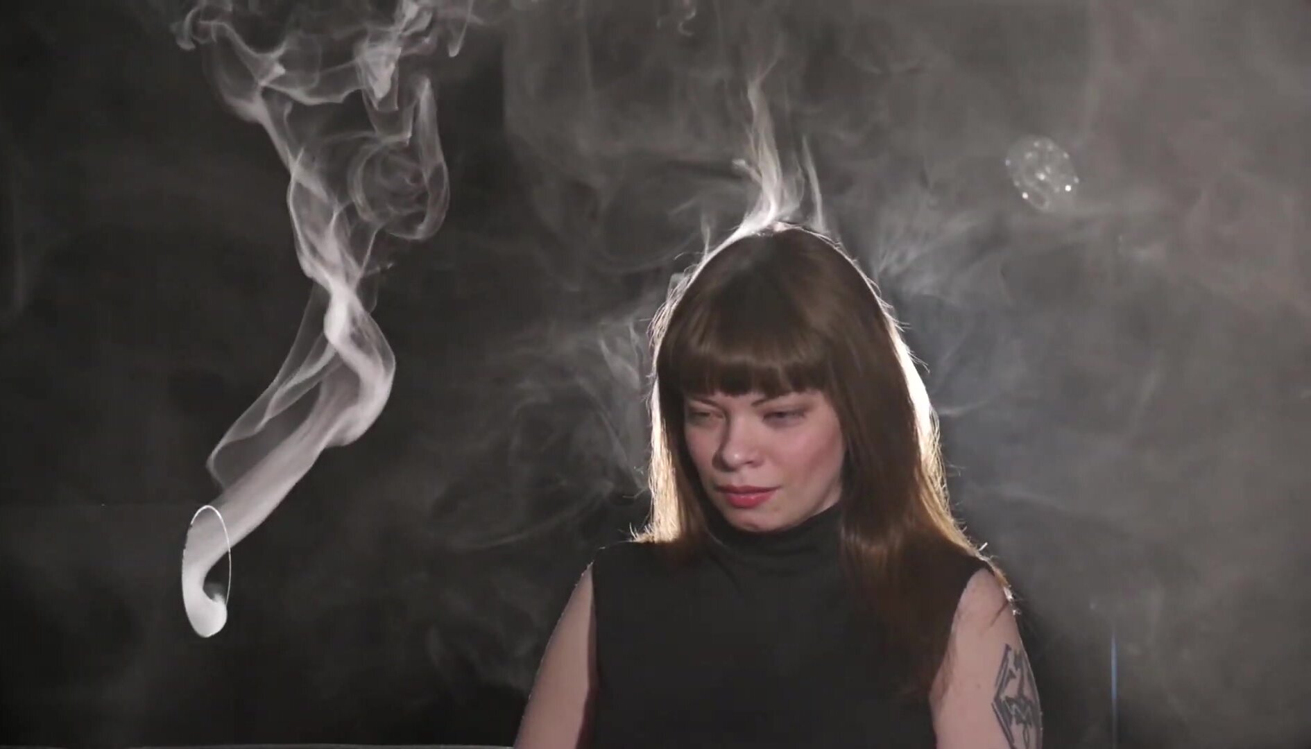 girl coughing by a smoke machine