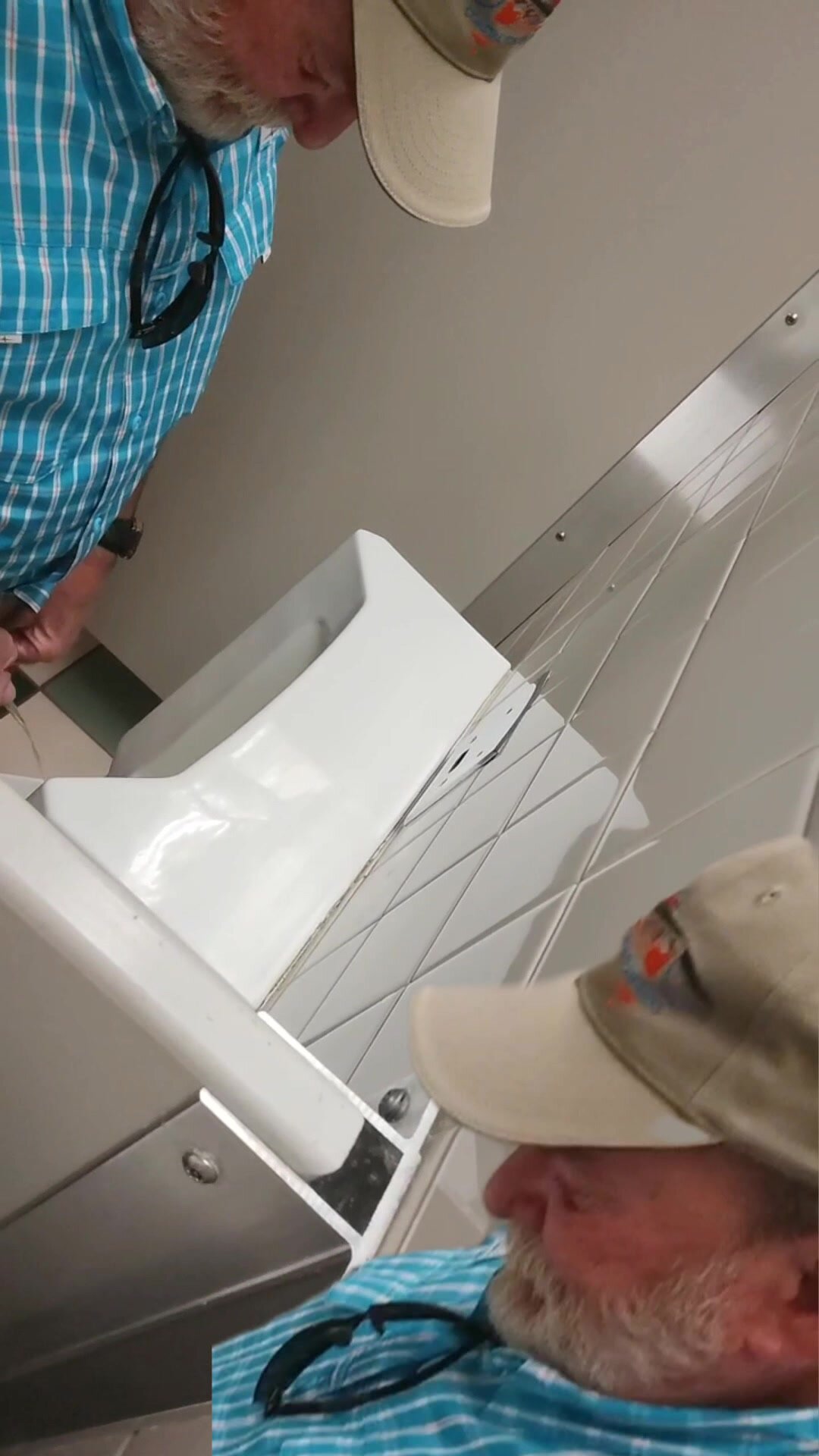 Bearded grandpa over divider urinal spy