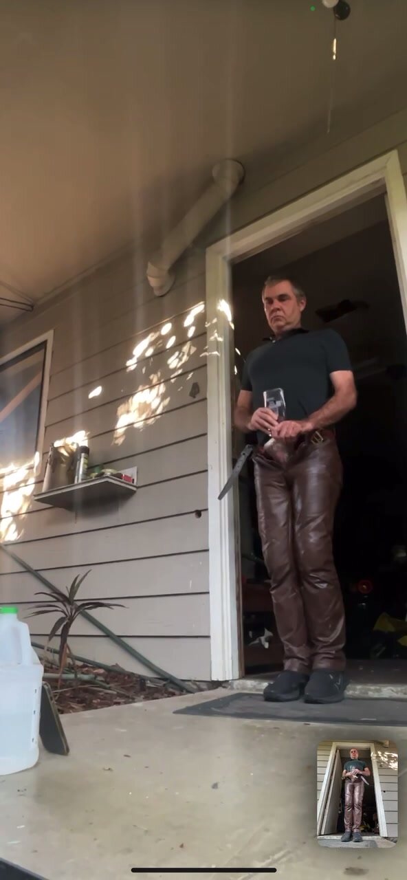 man masturbating in brown leather pants