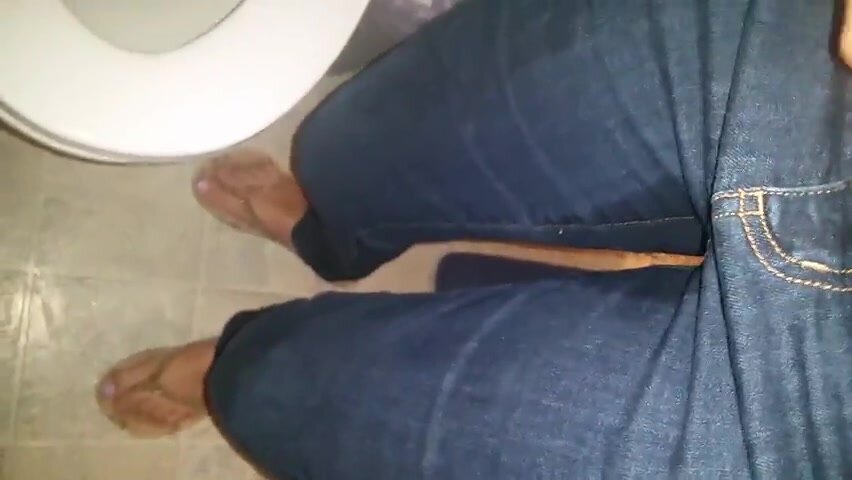 amateur girl wets her dark jeans on the toilet