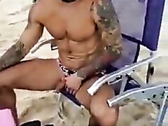 Uncut guy pissing at the beach