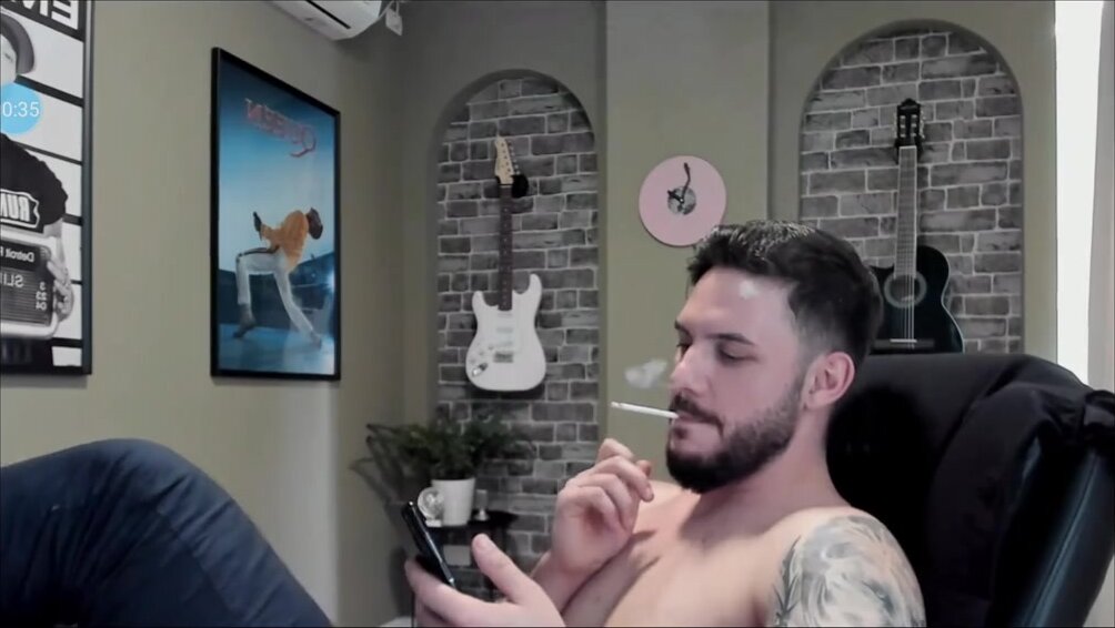 Sexy bearded man smoking topless