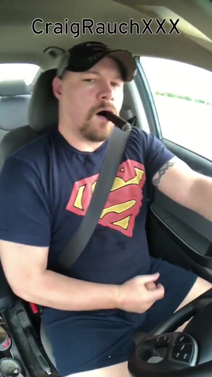 Young bear have a smoke and stroke in his car