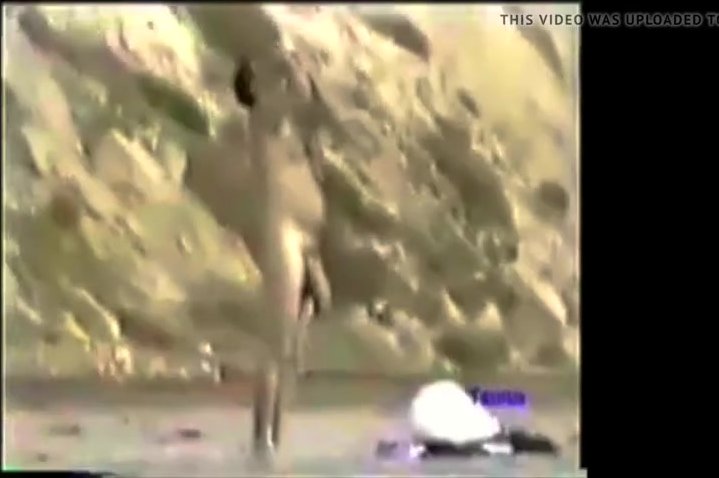 classic beach spy video of mystery horse hung man