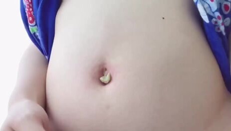 girl mess her belly button up with some mustard