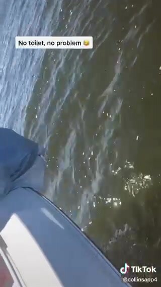 Girl pees off side of boat