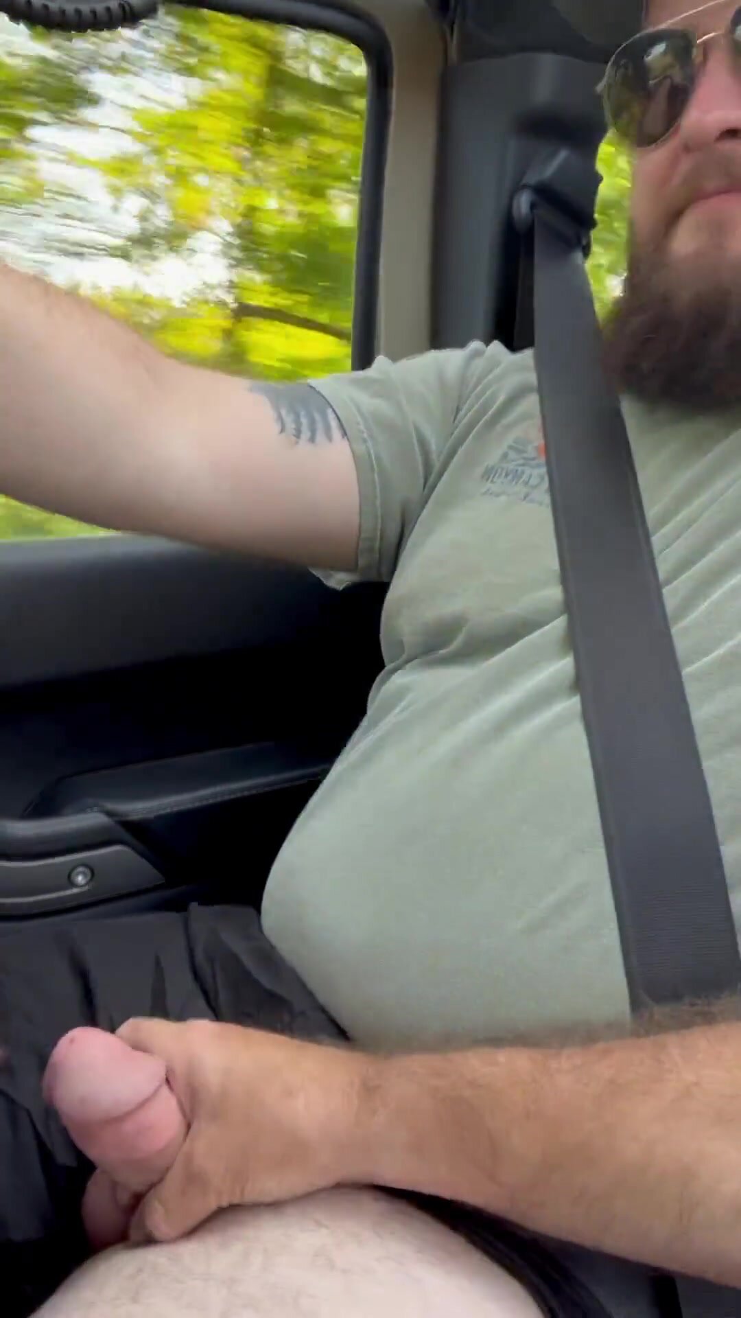 Stroking friends dick while driving