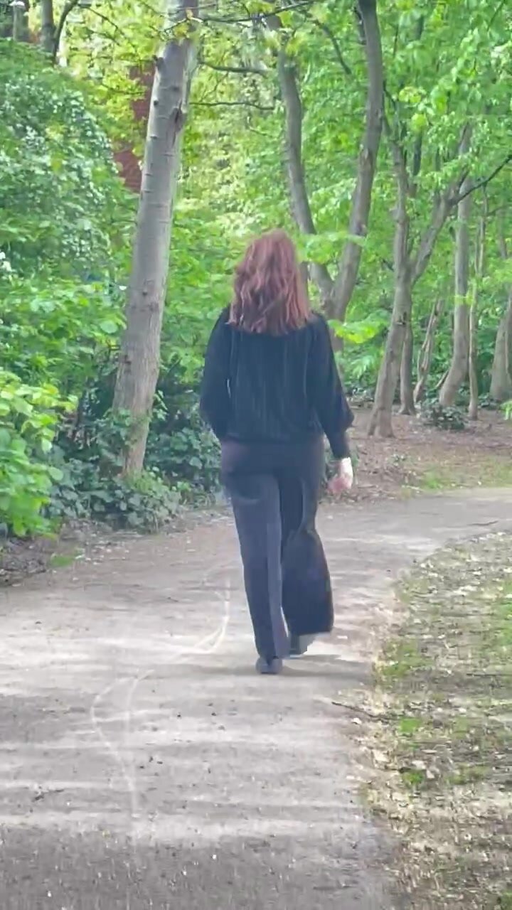 Brunette milf walking in the park
