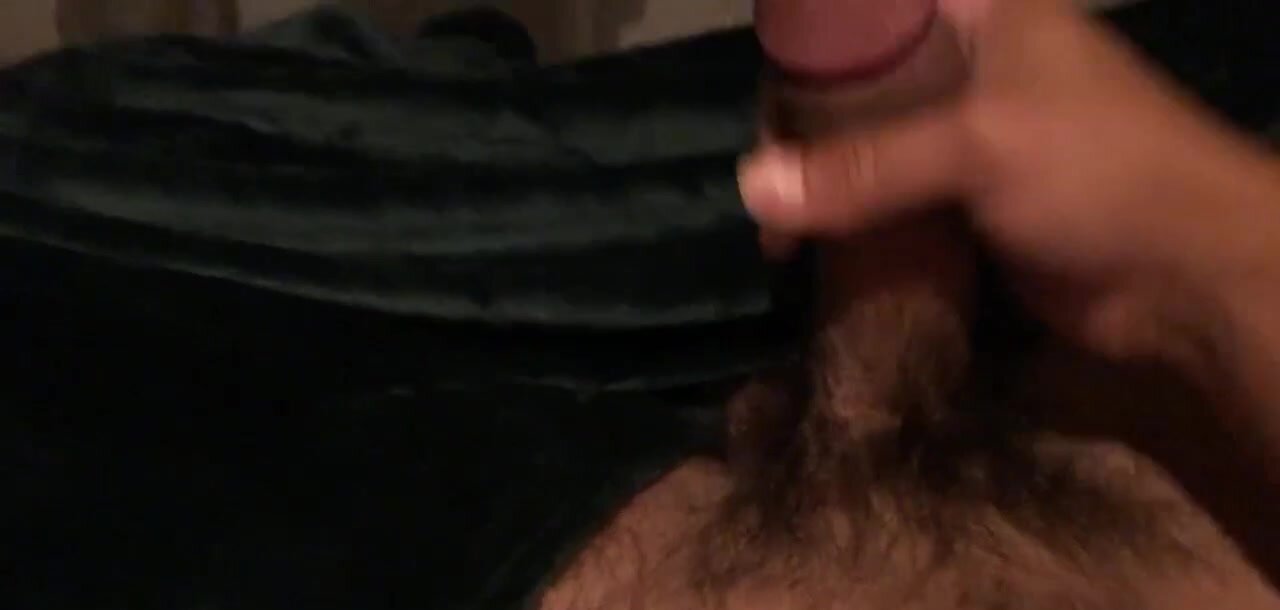 Hairy guy strokes his curved cock