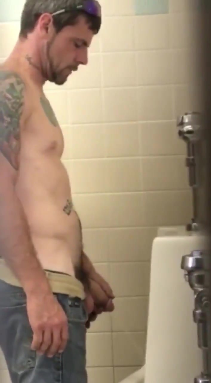 Working his cock while pissing