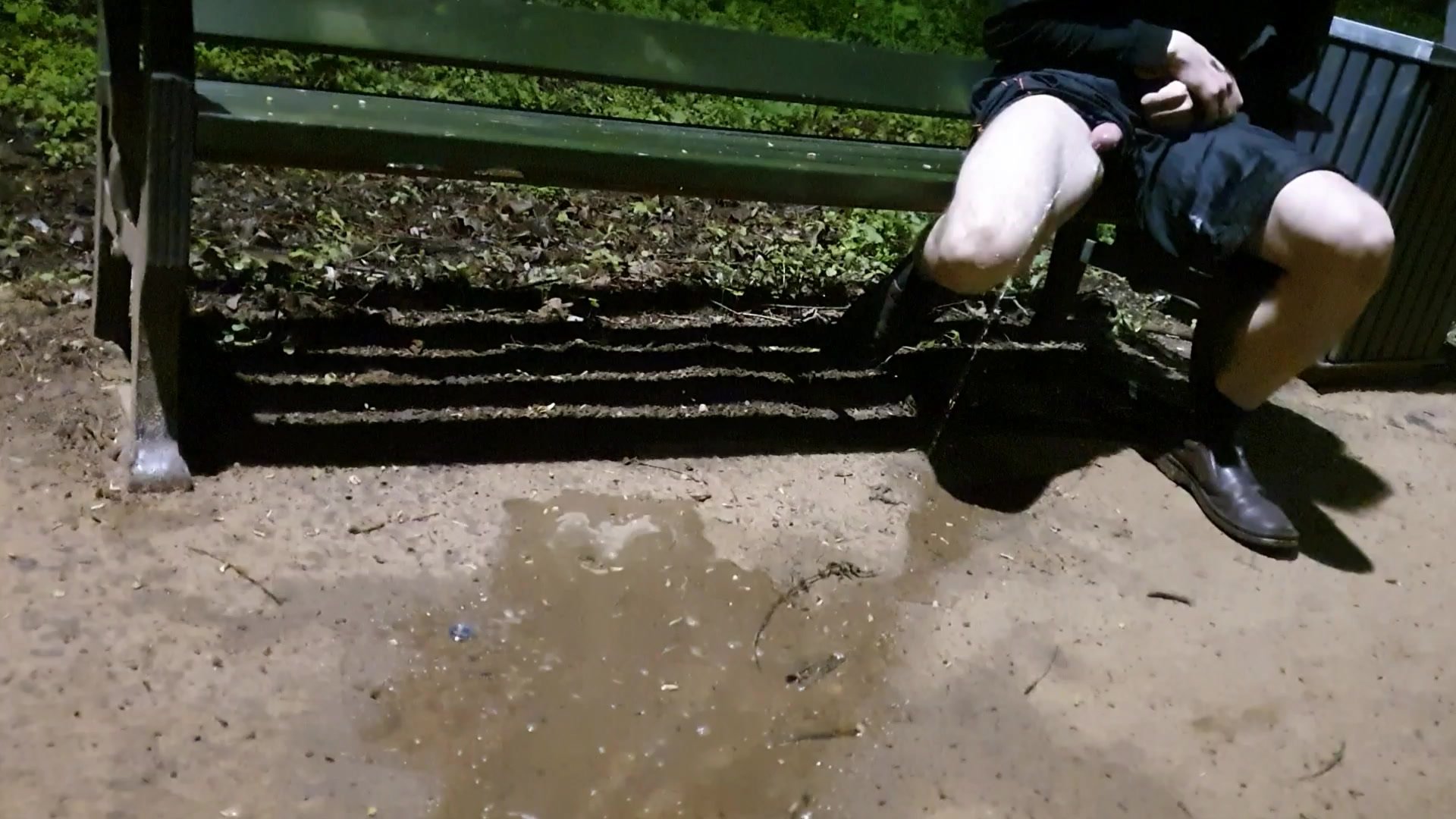 Desperate pissing on a bench in public park