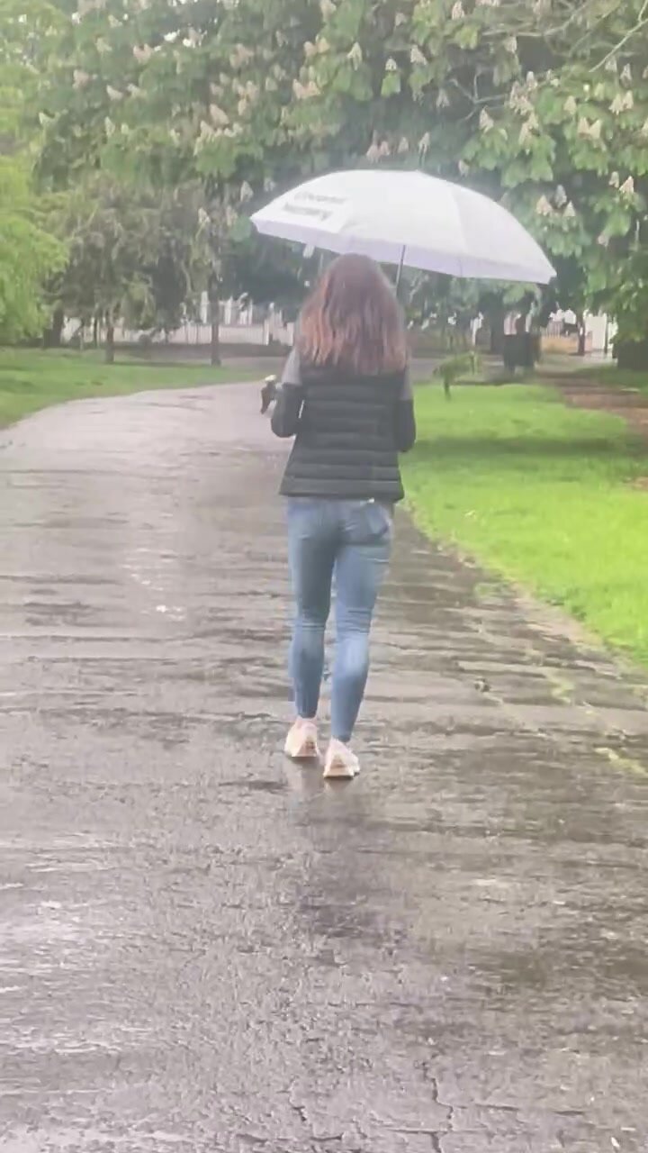 Petite brunette walking in the rain
