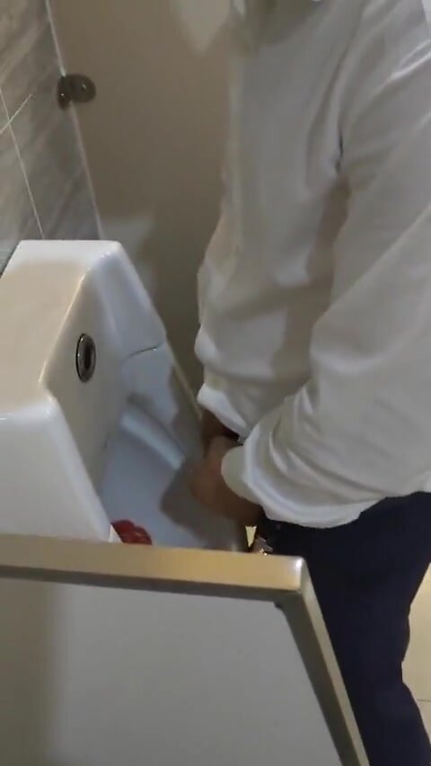 Males are pissing in the toilet. - video 4