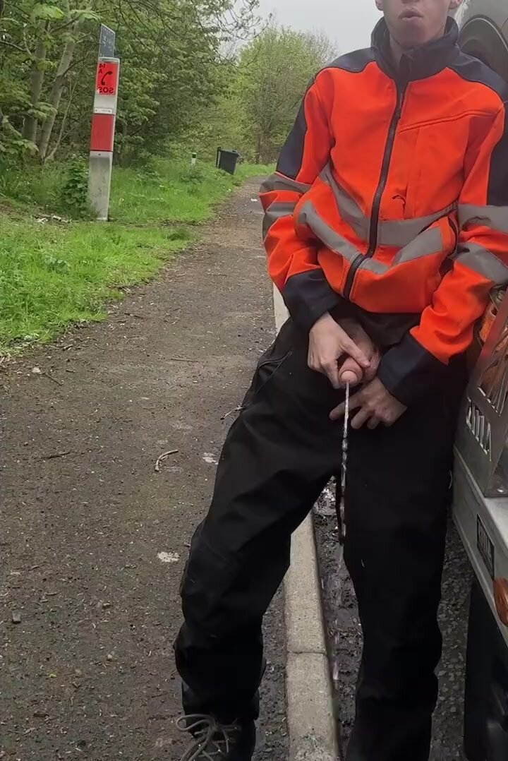 pissing next to his truck